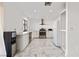 Modern kitchen with white cabinets, marble counters, and stainless steel appliances at 6564 Sweetzer Way, Las Vegas, NV 89108