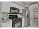 Close-up of the kitchen's stainless steel appliances, granite countertops, and white cabinets at 8300 La Strada Ave, Las Vegas, NV 89129