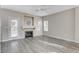 Inviting living room with a fireplace, wood-look flooring, and large windows at 8300 La Strada Ave, Las Vegas, NV 89129