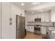 Modern kitchen with white cabinets, stainless steel appliances, and granite countertops at 8705 Villa Ridge Dr, Las Vegas, NV 89134