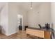 Home office with a view of the kitchen, wood desk and neutral color scheme at 8705 Villa Ridge Dr, Las Vegas, NV 89134