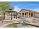 Landscaped backyard with gazebo, pond, and patio at 9092 National Park Dr, Las Vegas, NV 89178