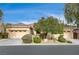 Single-story house with three-car garage and well-manicured landscaping at 9092 National Park Dr, Las Vegas, NV 89178