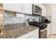 Kitchen boasts granite countertops and stainless steel appliances at 10311 Sequoia Falls Pl, Las Vegas, NV 89149