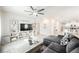 Living room features sectional sofa, TV stand, and ceiling fan at 10311 Sequoia Falls Pl, Las Vegas, NV 89149