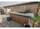 Modern outdoor kitchen with built-in BBQ and bar top at 10311 Sequoia Falls Pl, Las Vegas, NV 89149