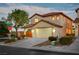 View of a two-story home's exterior with a driveway and landscaping at 10353 Cherokee Corner Ave, Las Vegas, NV 89129