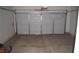 Two-car garage with white door and concrete floor at 10643 Petricola St # 103, Las Vegas, NV 89183