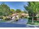 Beautiful home exterior with a red tile roof and lush landscaping at 128 Quail Run Rd, Henderson, NV 89014