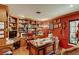 Bright home office with built-in bookshelves and a large desk at 128 Quail Run Rd, Henderson, NV 89014