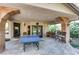 Outdoor patio with ping pong table and built-in grill at 128 Quail Run Rd, Henderson, NV 89014