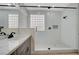 Modern bathroom with a large walk-in shower, marble countertops, and glass block window at 2603 Savannah Springs Ave, Henderson, NV 89052