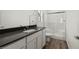 Bathroom with gray countertop, white cabinets, and a shower at 6275 Blood Lily Ave, Las Vegas, NV 89122