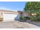 House exterior featuring a two-car garage and landscaping at 6657 Diamond Care Dr, Las Vegas, NV 89122