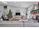 Large living room with hardwood floors, sectional sofa, and a Christmas tree at 7301 Bachelors Button Dr, Las Vegas, NV 89131