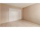 Spacious bedroom with tile floors and double door closet at 7556 Kalmalii Ave, Las Vegas, NV 89147