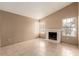 Spacious living area with tile floors and a fireplace at 7556 Kalmalii Ave, Las Vegas, NV 89147