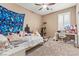 bedroom with playful decor, ceiling fan, and window with shutters at 778 Star Apple Ln, Las Vegas, NV 89178