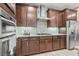 Kitchen with stainless steel appliances, granite countertop, and dark wood cabinets at 778 Star Apple Ln, Las Vegas, NV 89178