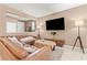 Living room with a leather sectional sofa, floor lamp, and entertainment center at 778 Star Apple Ln, Las Vegas, NV 89178