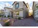 Two-story house with gray siding, stone accents, and a landscaped yard at 8044 Mercury Skye St, Las Vegas, NV 89166