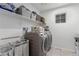 Laundry room with washer, dryer, and shelving at 8044 Mercury Skye St, Las Vegas, NV 89166