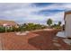 Large backyard with gravel, desert landscaping, and a stone path at 8516 Spyrun Dr, Las Vegas, NV 89134