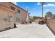 Concrete backyard with solar panels, HVAC units, and a shed at 8636 Grandbank Dr, Las Vegas, NV 89145