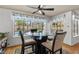 Bright breakfast nook with a glass-top table, wood floors, and views of the backyard pool at 8636 Grandbank Dr, Las Vegas, NV 89145