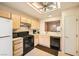 Kitchen features light wood cabinets, black appliances, and a pass-through to dining area at 9545 Gold Bank Dr, Las Vegas, NV 89134