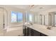 Bathroom with double vanity and soaking tub at 9893 Canyon Peak Dr, Las Vegas, NV 89147