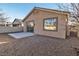 Tan house exterior with sliding glass doors and a small yard at 10200 Wood Work Ln, Las Vegas, NV 89135