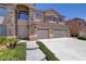 Two-story house with three-car garage and landscaped front yard at 180 Tad Moore Ave, Las Vegas, NV 89148