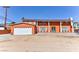 Two-story house with a large white garage and orange exterior at 1818 Waldman Ave, Las Vegas, NV 89102