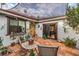 Cozy courtyard with seating area, potted plants, and access to the home's entrance at 2465 El Paseo Cir, Las Vegas, NV 89121