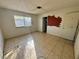 Spacious bedroom with tile flooring, large window, and partially painted walls at 2500 Holly Ave, Las Vegas, NV 89106