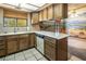 View of kitchen with wood cabinets, a mural, and stainless steel appliances at 5425 W Meranto Ave, Las Vegas, NV 89139