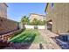 Landscaped backyard with artificial turf and patio at 5843 Aimless St, Henderson, NV 89011