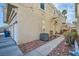 Side view of house, showing walkway, landscaping, and garage at 6459 Rusticated Stone Ave # 101, Henderson, NV 89011