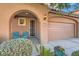 Front entry with arched entryway and teal chairs at 6989 Florido Rd, Las Vegas, NV 89178