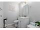 Clean bathroom with white vanity, toilet and light wood-look floor at 7078 Burcot Ave # B15, Las Vegas, NV 89156