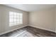 Simple bedroom with wood-look floors and a large window at 911 Rifle Dr, Henderson, NV 89002