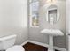 Simple bathroom with pedestal sink and dark hardwood floor at 10032 Emerald Pools St, Las Vegas, NV 89178