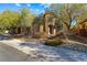 Two-story house with stone accents and landscaping at 10032 Emerald Pools St, Las Vegas, NV 89178