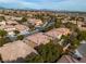 Aerial view of a residential neighborhood with houses and streets at 11045 Village Ridge Ln, Las Vegas, NV 89135