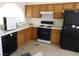 Galley kitchen with wood cabinets and appliances at 1113 Cloudy Day Dr, Henderson, NV 89074