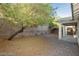 Landscaped backyard with gravel, a tree, and covered patio at 11204 Newbury Hills Ave, Las Vegas, NV 89138