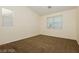 Simple bedroom with carpeted floor and large window at 11204 Newbury Hills Ave, Las Vegas, NV 89138