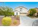 Two-story house with attached garage and manicured lawn at 11204 Newbury Hills Ave, Las Vegas, NV 89138