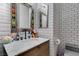 Bathroom with white subway tile, marble vanity, and unique mirror frame at 11644 Royal Derwent Dr, Las Vegas, NV 89138